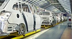 white cars being manufactured in a plant