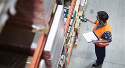  Licensed Worker with scanner making review of goods in warehouse 