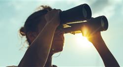 woman looking through binoculars