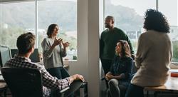 Diverse designers discussing a project during an office meeting