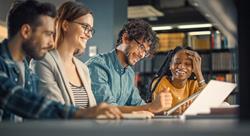 Diverse group of students working together in the library